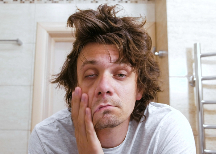 man experiencinig hang over in the morning