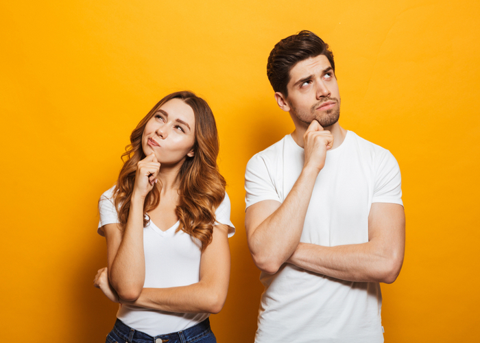  man and woman in basic clothing thinking and touching chin while looking aside isolated over yellow background